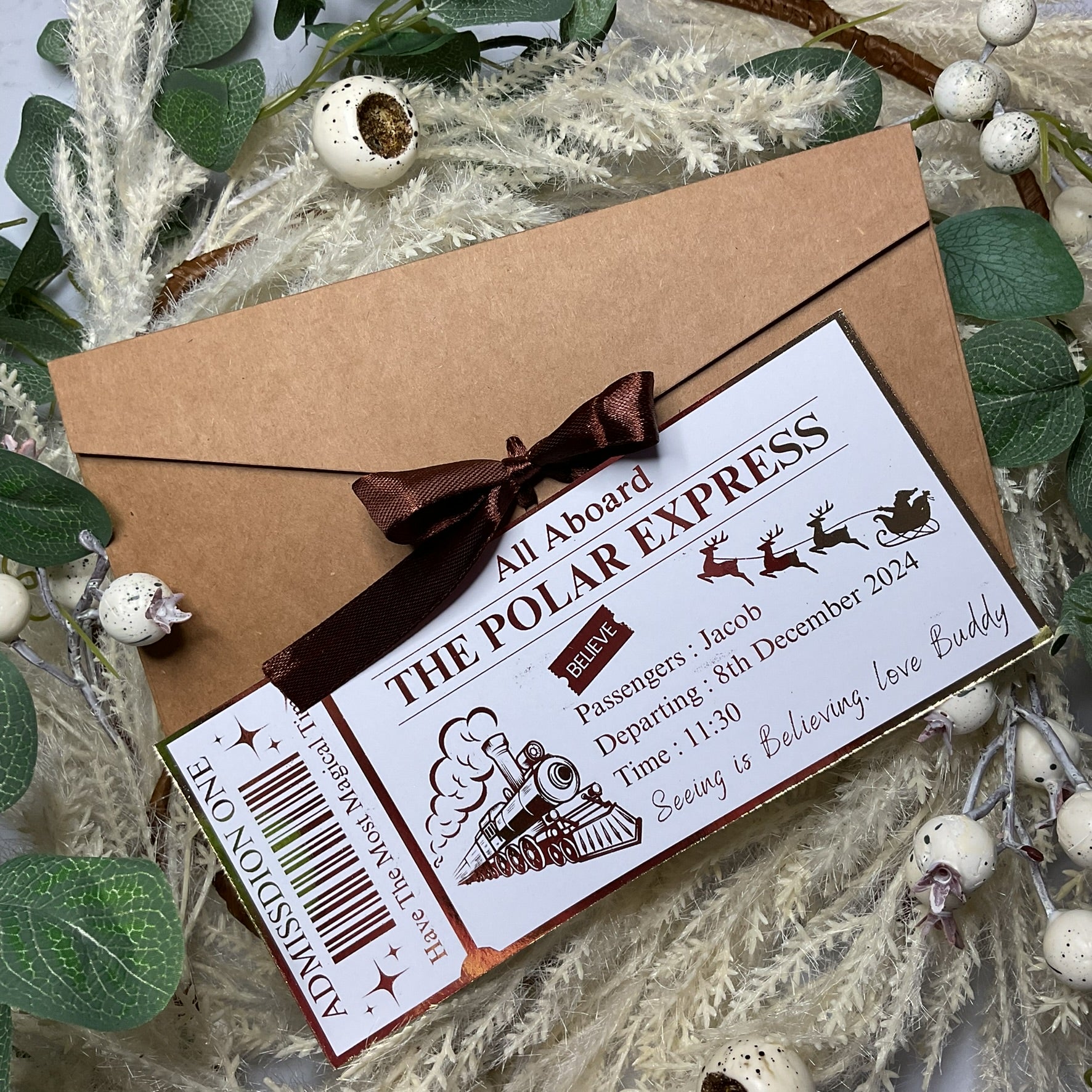 Polar Express foiled ticket with a brown envelope on a decorative background
